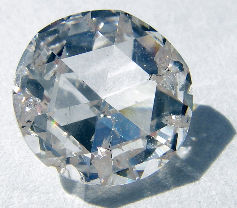 A clear and polished diamond on a white background